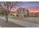 Exterior side view of home showcasing stone facade, desert landscaping, and gated access at 22186 E Via Del Verde --, Queen Creek, AZ 85142