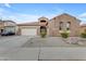 Beautiful home showcasing a three-car garage, manicured landscaping, and a stone-accented facade at 22186 E Via Del Verde --, Queen Creek, AZ 85142