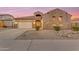 Charming single-Gathering home featuring a stucco and stone facade, a two-car garage, and neat desert landscaping at 22186 E Via Del Verde --, Queen Creek, AZ 85142