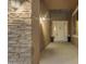 Inviting front porch with stone accents, elegant lighting, and a welcoming front door with sidelights at 22186 E Via Del Verde --, Queen Creek, AZ 85142
