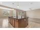 Open-concept kitchen features a granite island with pendant lighting and stainless steel appliances at 22186 E Via Del Verde --, Queen Creek, AZ 85142