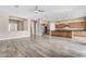 Open-concept living space features wood-look tile and a seamless transition to the modern kitchen at 22186 E Via Del Verde --, Queen Creek, AZ 85142