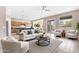 Open concept living room with wood floors, neutral tones, ceiling fan, and sliding glass doors to the outdoors at 22186 E Via Del Verde --, Queen Creek, AZ 85142