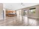 Spacious living area with wood-look tile, open to kitchen, and sliding glass doors to the outdoors at 22186 E Via Del Verde --, Queen Creek, AZ 85142