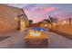Inviting backyard pool area with travertine tile, fire bowls and cozy fire pit, perfect for evening relaxation at 22186 E Via Del Verde --, Queen Creek, AZ 85142