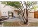 View of the home's back patio and outdoor seating area with brick pavers and mature landscaping at 2221 W Farmdale Ave # 7, Mesa, AZ 85202