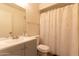 Bright bathroom with single sink vanity and shower with curtain at 2221 W Farmdale Ave # 7, Mesa, AZ 85202