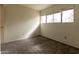 Neutral bedroom features gray carpet and large window at 2221 W Farmdale Ave # 7, Mesa, AZ 85202