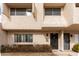 Townhome exterior showcasing beige stucco, multi-pane windows, and a covered front entryway at 2221 W Farmdale Ave # 7, Mesa, AZ 85202