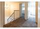 Upstairs hallway features carpet and a view of a chandelier hanging above the stairs at 2221 W Farmdale Ave # 7, Mesa, AZ 85202