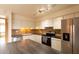 Modern kitchen with stainless steel appliances, island, and custom countertops at 2221 W Farmdale Ave # 7, Mesa, AZ 85202