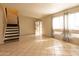 Bright living room features tile flooring, natural light, an open staircase, and front entry at 2221 W Farmdale Ave # 7, Mesa, AZ 85202