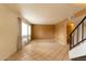 Spacious living room with tile flooring, natural light, and an open staircase to the upper level at 2221 W Farmdale Ave # 7, Mesa, AZ 85202