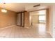 Living room featuring tile floors, and sliding corrugated metal barn doors at 2221 W Farmdale Ave # 7, Mesa, AZ 85202