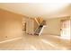 Open living room area with tile flooring, staircase to the upper level, and an entryway at 2221 W Farmdale Ave # 7, Mesa, AZ 85202