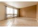 Bright, spacious living room with tile flooring, large windows with sheer curtains, and neutral walls at 2221 W Farmdale Ave # 7, Mesa, AZ 85202