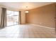 Bright living room features tile floors and a sliding glass door to backyard at 2221 W Farmdale Ave # 7, Mesa, AZ 85202