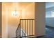 Bright staircase featuring carpet, rail and a view of a chandelier hanging above at 2221 W Farmdale Ave # 7, Mesa, AZ 85202