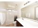 Bathroom with a tub-shower combo, large mirror, and vanity sink at 24113 N 26Th Pl, Phoenix, AZ 85024