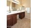 Bright bathroom with double sink vanity with dark wood cabinets and a large mirror at 24113 N 26Th Pl, Phoenix, AZ 85024