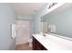 Bright bathroom with a tub-shower combo, a large mirror, and ample lighting at 24113 N 26Th Pl, Phoenix, AZ 85024