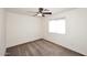 Empty carpeted bedroom with ceiling fan and natural light from a window at 24113 N 26Th Pl, Phoenix, AZ 85024