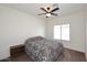 Cozy bedroom with a patterned comforter, side table, and a bright window at 24113 N 26Th Pl, Phoenix, AZ 85024