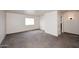 A spacious bedroom with plush carpeting, a window, and ample natural light at 24113 N 26Th Pl, Phoenix, AZ 85024