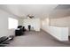 Bright bonus room with neutral carpeting, a ceiling fan and views of the backyard at 24113 N 26Th Pl, Phoenix, AZ 85024