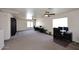 Spacious bonus room featuring neutral carpeting, dual ceiling fans, and a large bright window at 24113 N 26Th Pl, Phoenix, AZ 85024