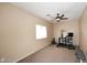 Home gym with carpet, ceiling fan, and lots of weights and exercise equipment at 24113 N 26Th Pl, Phoenix, AZ 85024