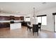 Elegant kitchen with adjacent breakfast nook and dark wood cabinetry at 24113 N 26Th Pl, Phoenix, AZ 85024