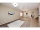 Living room with neutral paint colors, tile flooring, and staircase access at 24113 N 26Th Pl, Phoenix, AZ 85024