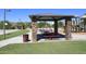 A picnic area with stone columns and picnic tables next to a colorful playground in a community park at 24113 N 26Th Pl, Phoenix, AZ 85024
