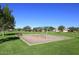 Swinging set in a community park featuring lush green grass and trees on a bright, sunny day at 24113 N 26Th Pl, Phoenix, AZ 85024