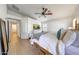 Bright bedroom featuring a ceiling fan, wood floors, and ample natural light at 2414 W White Feather Ln, Phoenix, AZ 85085
