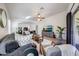 Open living area with backyard view, wood floors, stylish furnishings, and seamless flow to the kitchen at 2414 W White Feather Ln, Phoenix, AZ 85085