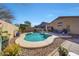 Beautiful backyard with a sparkling private pool, desert landscaping, and patio area for entertaining at 2414 W White Feather Ln, Phoenix, AZ 85085
