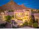 Backyard view of the home with a water feature, luxurious lounge area, and desert mountain views at 24350 N Whispering Ridge Way # 22, Scottsdale, AZ 85255