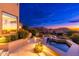 Stunning backyard view at twilight with a water feature, beautiful landscaping, and mountain views at 24350 N Whispering Ridge Way # 22, Scottsdale, AZ 85255