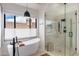 Bright bathroom featuring a freestanding tub, a modern shower, and a window with natural light at 24350 N Whispering Ridge Way # 22, Scottsdale, AZ 85255