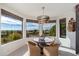 Bright dining area with elegant chandelier and panoramic views from multiple windows at 24350 N Whispering Ridge Way # 22, Scottsdale, AZ 85255