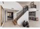 Bright foyer with staircase, tile flooring, and decorative vases leading to adjacent rooms at 24350 N Whispering Ridge Way # 22, Scottsdale, AZ 85255