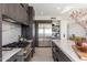Open concept kitchen with stainless appliances, custom cabinets, and marble countertops at 24350 N Whispering Ridge Way # 22, Scottsdale, AZ 85255
