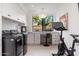 Laundry room featuring a desk with modern appliances, a chandelier, and a fitness bike at 24350 N Whispering Ridge Way # 22, Scottsdale, AZ 85255
