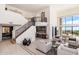 Bright living room with soaring ceilings, a staircase, and a convenient wet bar at 24350 N Whispering Ridge Way # 22, Scottsdale, AZ 85255