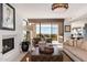 Comfortable living room with fireplace, plush seating, and beautiful outdoor views at 24350 N Whispering Ridge Way # 22, Scottsdale, AZ 85255
