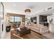 Bright living room showcasing a modern sofa, area rug, and seamless access to the kitchen at 24350 N Whispering Ridge Way # 22, Scottsdale, AZ 85255