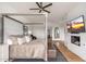 Inviting main bedroom with a four-poster bed, fireplace, and large windows with natural light at 24350 N Whispering Ridge Way # 22, Scottsdale, AZ 85255