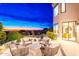 Outdoor patio at dusk with comfortable seating and scenic views overlooking the valley at 24350 N Whispering Ridge Way # 22, Scottsdale, AZ 85255